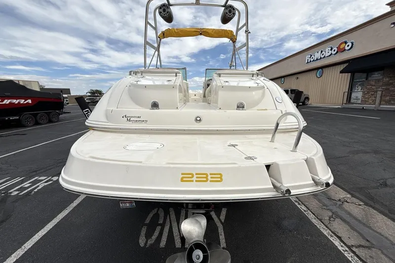 Slide: The Image of 2005 Monterey 233 Explorer Sport boat parked outdoors, showcasing rear view and propeller. - 4