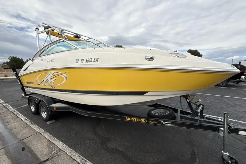 Slide: The Image of 2005 Monterey 233 Explorer Sport boat on trailer, featuring a yellow and white design. - 7