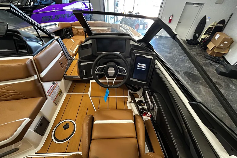 Slide: The Image of 2025 Supra SA boat interior with brown leather seats and modern dashboard. - 7
