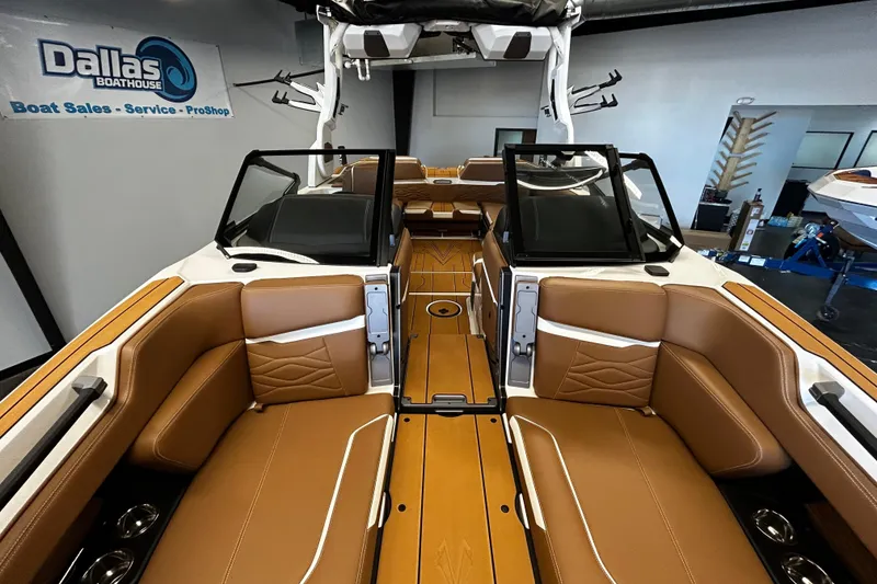 Slide: The Image of 2025 Supra SA boat interior with tan leather seats at Dallas Boathouse showroom. - 8