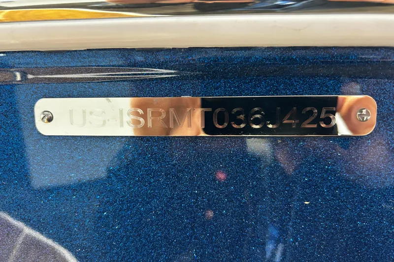 Slide: The Image of 2025 Supra SA boat identification plate on metallic blue surface. - 9