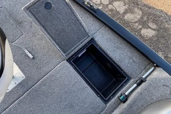 Slide: The Image of 2014 G3 Eagle 166 SE boat interior storage compartment with gray carpet. - 17