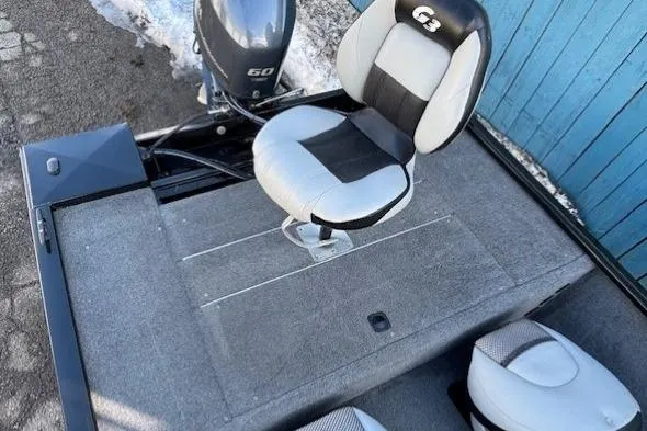 Slide: The Image of 2014 G3 Eagle 166 SE boat interior with seating and motor. - 27