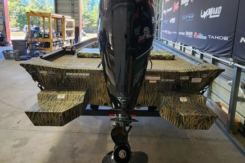 Slide: The Image of 2025 Tracker Grizzly 1860 CC boat with camo design and powerful outboard motor. - 3