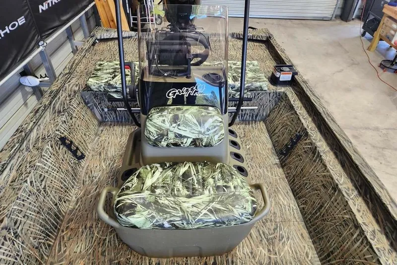 Slide: The Image of 2025 Tracker Grizzly 1860 CC boat with camouflage seating and interior design. - 8