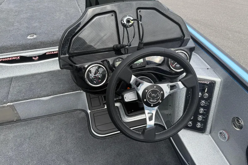 Slide: The Image of 2026 Phoenix 20 XE boat dashboard with steering wheel and control panel. - 12