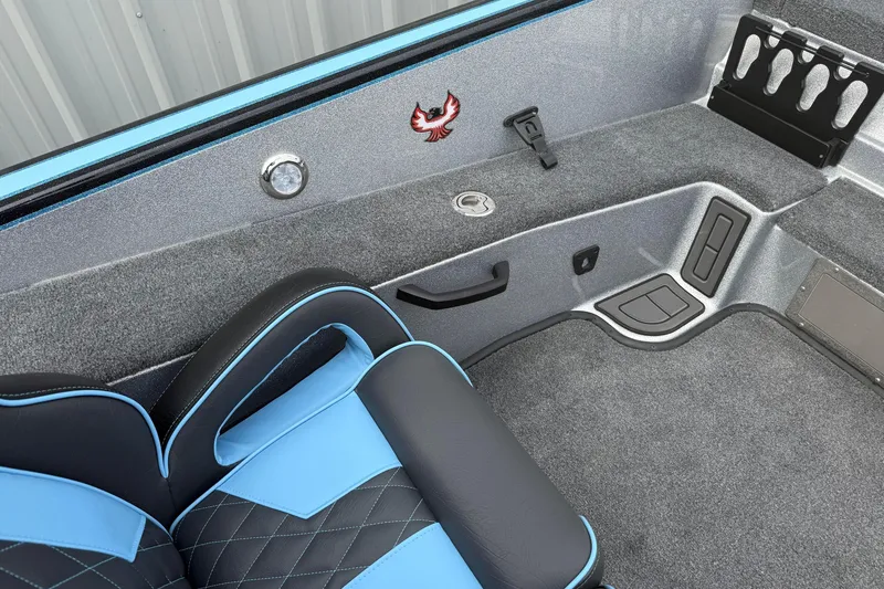 Slide: The Image of 2026 Phoenix 20 XE boat interior with blue and black seating, carpeted flooring, and storage compartments. - 14