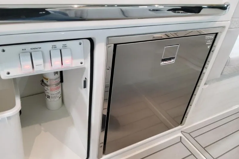 Slide: The Image of Control panel and storage on 2026 Formula 360 Crossover Bowrider I/O boat. - 34