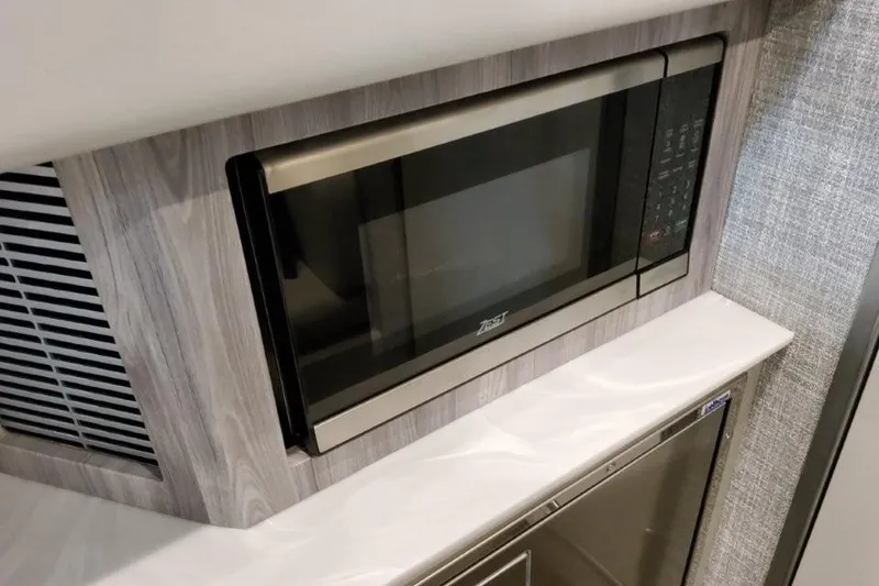 Slide: The Image of 2026 Formula 360 Crossover Bowrider I/O interior with modern microwave and cabinetry. - 39