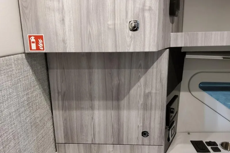 Slide: The Image of Interior of 2026 Formula 360 Crossover Bowrider I/O with wood finish and fire extinguisher sign. - 41