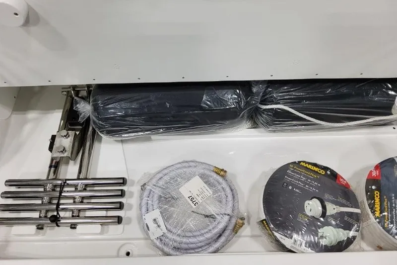 Slide: The Image of Storage compartment of 2026 Formula 360 Crossover Bowrider I/O with marine accessories. - 50