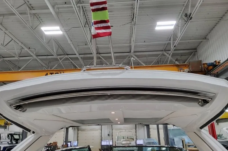 Slide: The Image of 2026 Formula 360 Crossover Bowrider I/O in a warehouse, showcasing sleek design and modern features. - 51