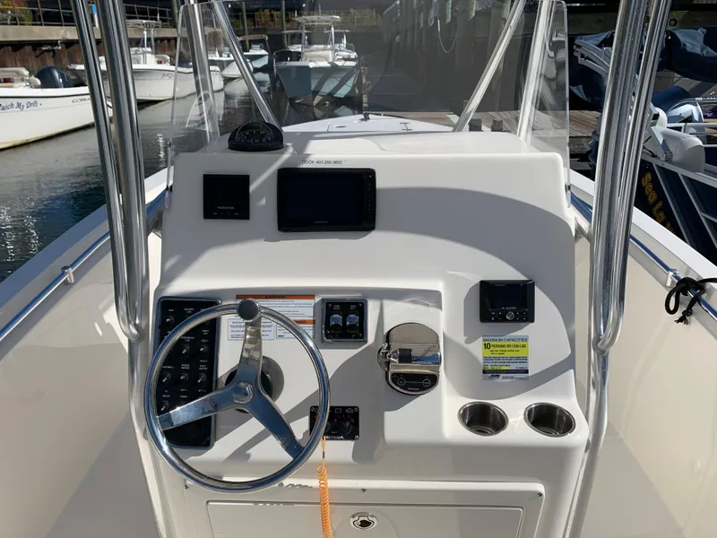 Slide: The Image of Cobia 237 Center Console 2020 helm with steering wheel and instruments. - 10