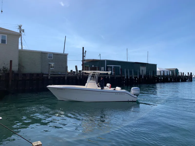 Slide: The Image of 2020 Cobia 237 Center Console boat in harbor. - 3