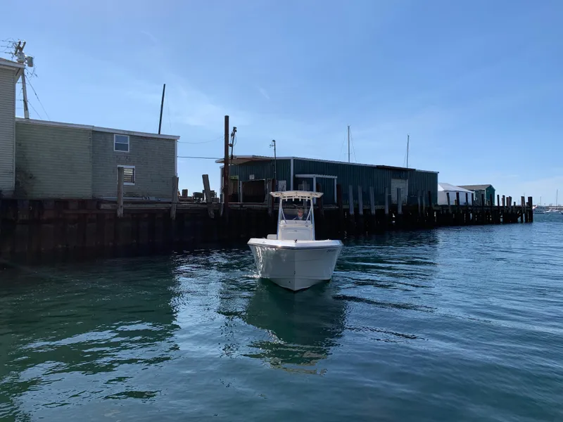 Slide: The Image of 2020 Cobia 237 Center Console boat near dock. - 4