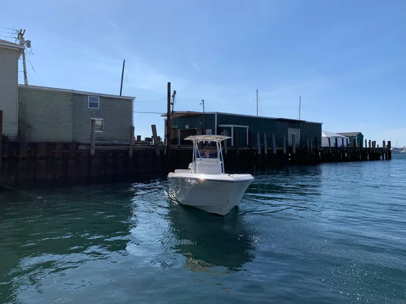 Slide: The Image of 2020 Cobia 237 Center Console boat in harbor. - 5