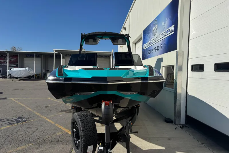 Slide: The Image of 2026 Supra SA 575 boat in vibrant teal and black, displayed outdoors. - 3