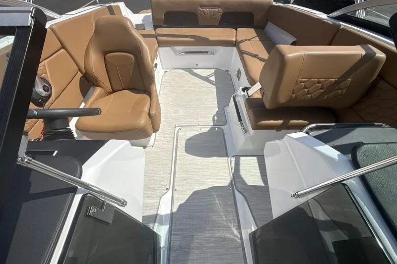 Slide: The Image of 2024 Four Winns H1 OB boat interior with tan leather seating and modern design. - 12