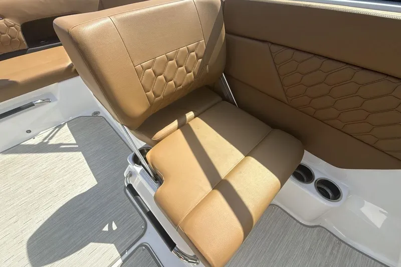 Slide: The Image of 2024 Four Winns H1 OB boat interior with brown leather seating and modern design. - 17