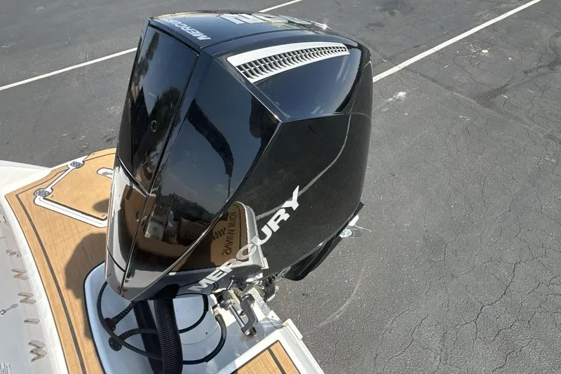 Slide: The Image of 2024 Four Winns H1 OB with Mercury outboard engine, parked on asphalt. - 20