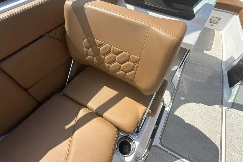 Slide: The Image of 2024 Four Winns H1 OB boat interior with tan leather seating and hexagonal stitching design. - 21