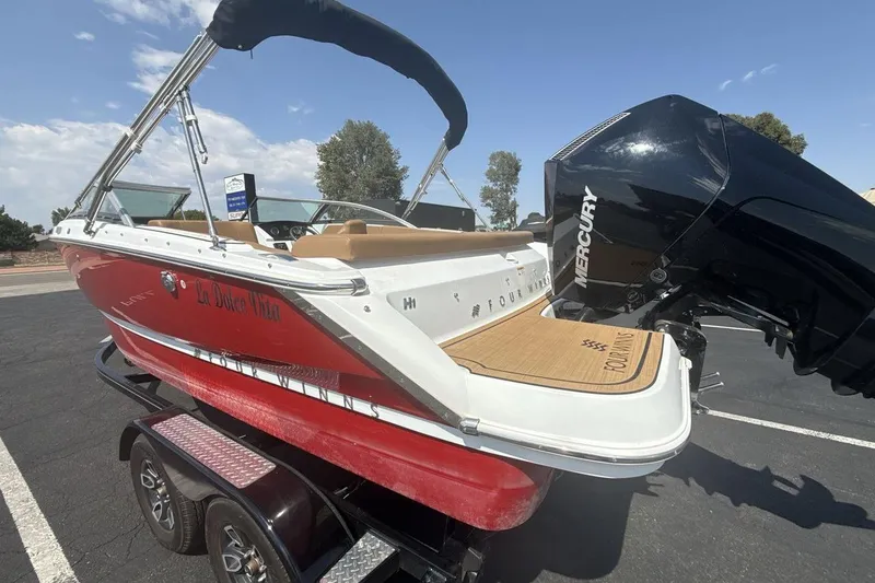 Slide: The Image of 2024 Four Winns H1 OB boat with Mercury outboard engine on trailer. - 3