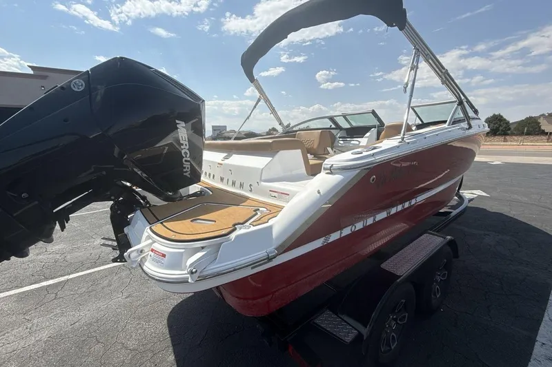 Slide: The Image of 2024 Four Winns H1 OB boat with Mercury outboard engine on a trailer. - 5