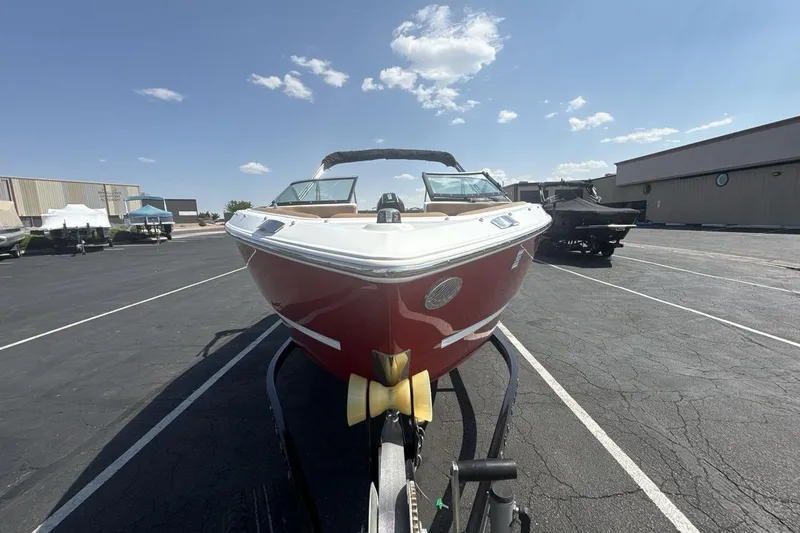 Slide: The Image of 2024 Four Winns H1 OB boat on trailer, parked outdoors under a clear sky. - 8