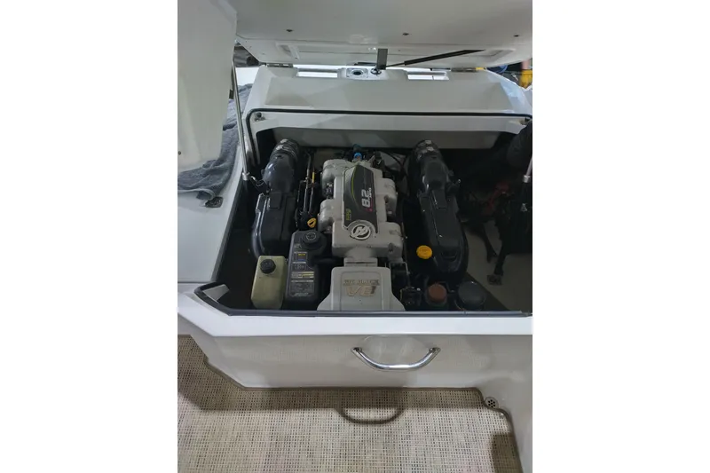 Slide: The Image of 2015 Cobalt 24SD boat engine compartment with visible components. - 11
