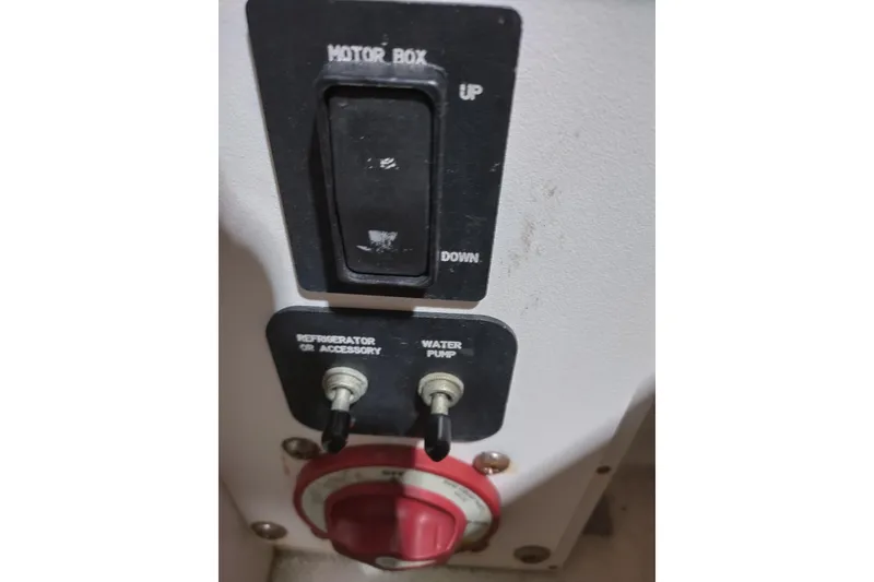 Slide: The Image of Control panel of a 2015 Cobalt 24SD boat with switches and dials. - 12