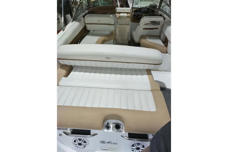 Slide: The Image of 2015 Cobalt 24SD boat interior with white and beige seating, showcasing luxury design. - 14