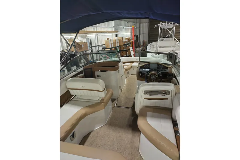 Slide: The Image of 2015 Cobalt 24SD boat interior with beige seating and modern dashboard. - 15