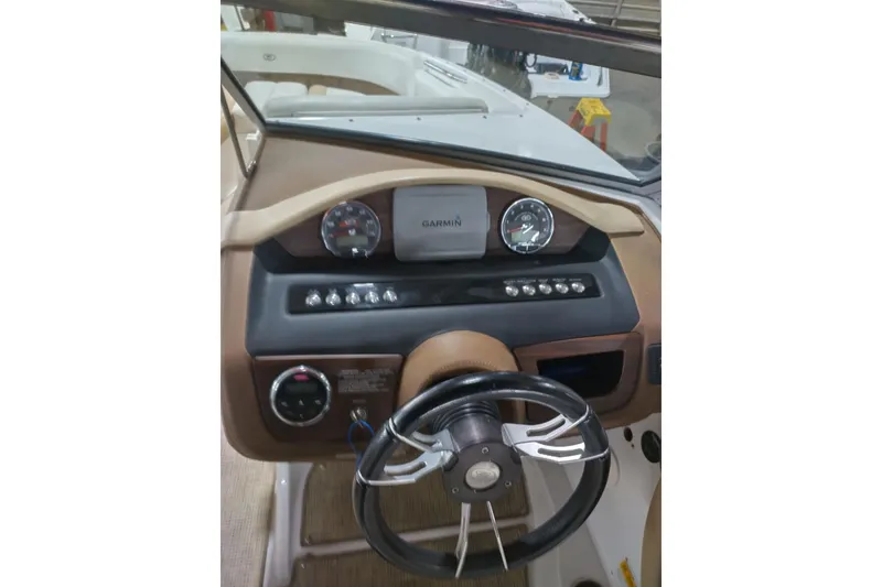 Slide: The Image of 2015 Cobalt 24SD boat dashboard with Garmin display and steering wheel. - 16