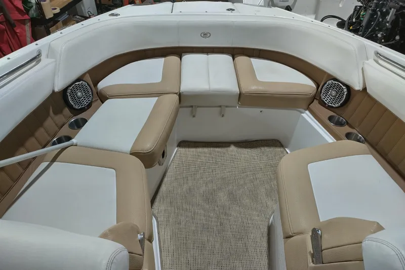 Slide: The Image of Luxurious seating area in a 2015 Cobalt 24SD boat with beige and white upholstery. - 21