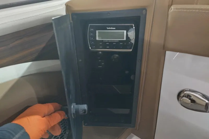 Slide: The Image of Control panel inside a 2015 Cobalt 24SD boat, featuring a Rockford Fosgate audio system. - 25
