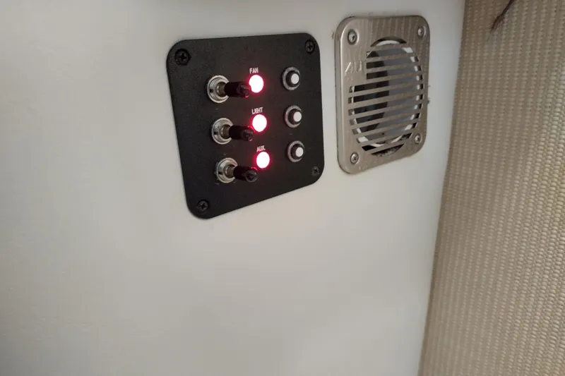 Slide: The Image of Control panel with switches and lights in a 2015 Cobalt 24SD boat. - 26