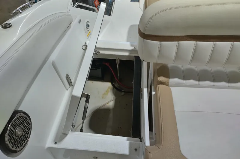 Slide: The Image of 2015 Cobalt 24SD boat interior with open storage compartment and seating. - 29