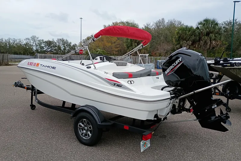 Slide: The Image of 2026 Tahoe T16 boat with Mercury engine on trailer, featuring red canopy. - 2