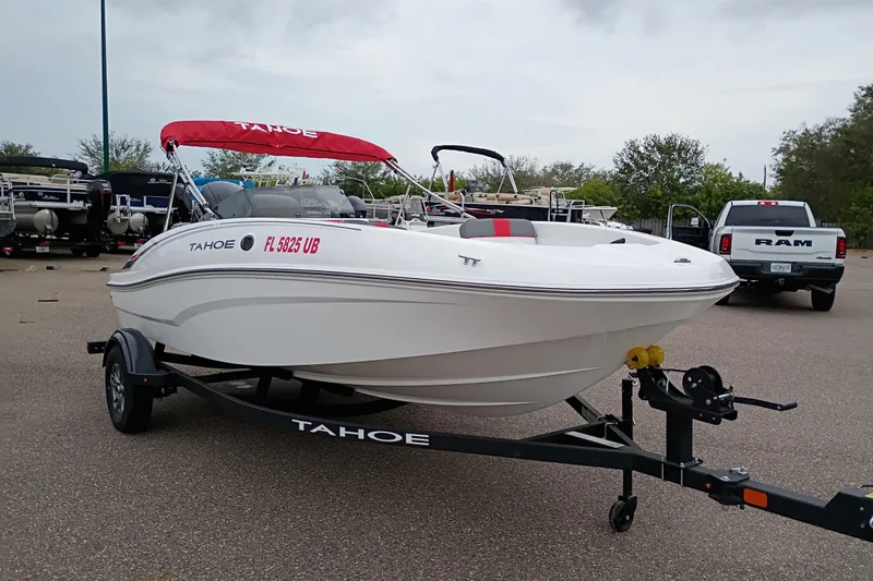 Slide: The Image of 2026 Tahoe T16 boat on trailer with red canopy in parking lot. - 6