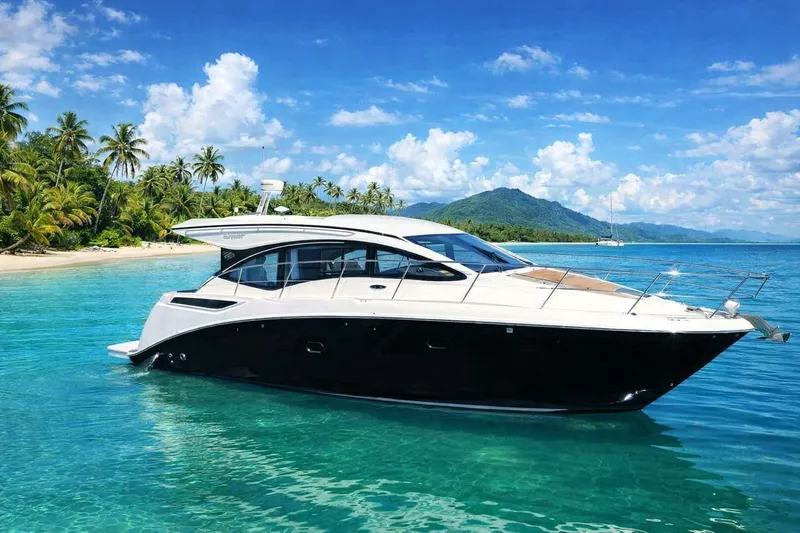 The Image of 2016 Sea Ray Sundancer 400 yacht in tropical waters near a palm-lined beach. - 0