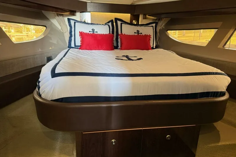 Slide: The Image of Luxurious 2016 Sea Ray Sundancer 400 cabin with nautical-themed bedding. - 11