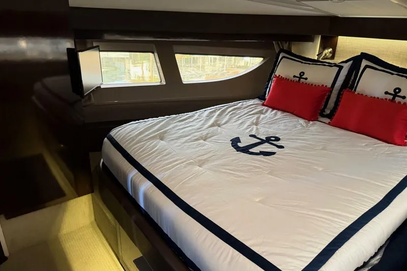 Slide: The Image of Luxurious cabin interior of 2016 Sea Ray Sundancer 400 with nautical-themed bedding. - 12