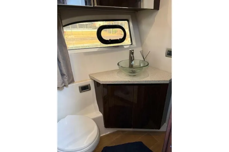 Slide: The Image of Bathroom interior of 2016 Sea Ray Sundancer 400 yacht with modern sink and window. - 16