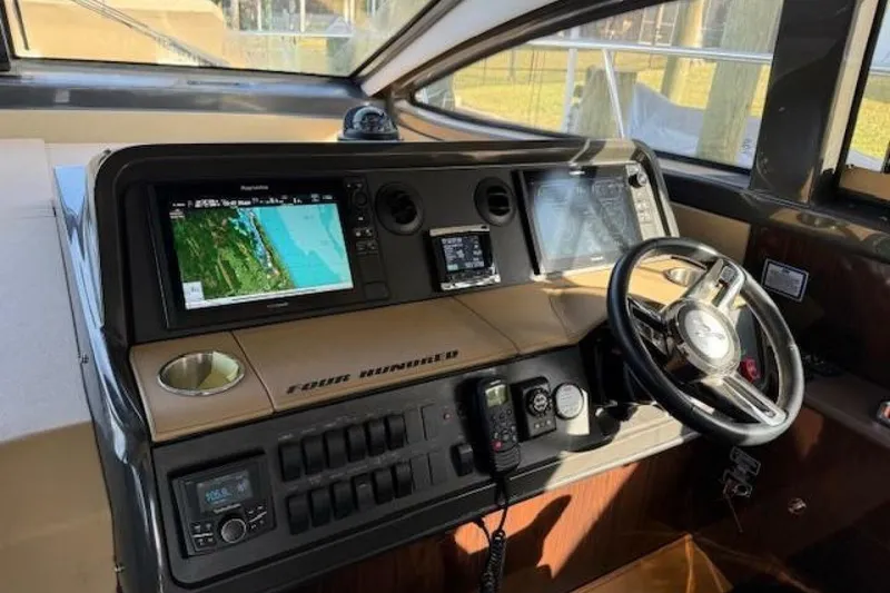 Slide: The Image of Helm of 2016 Sea Ray Sundancer 400 with navigation screens and controls. - 2