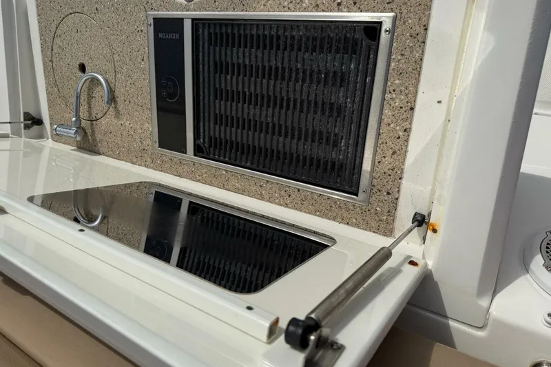 Slide: The Image of 2016 Sea Ray Sundancer 400 boat kitchen with stove and grill. - 24