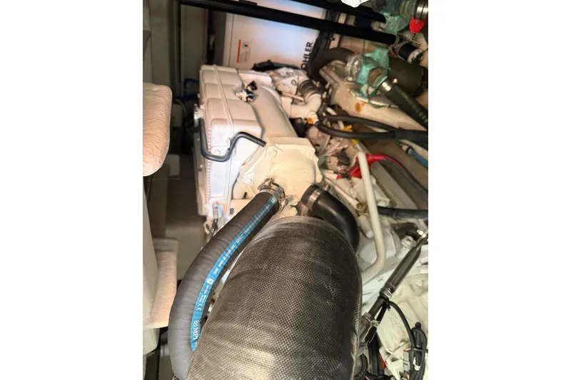 Slide: The Image of Engine compartment of a 2016 Sea Ray Sundancer 400 boat, showcasing mechanical components. - 27