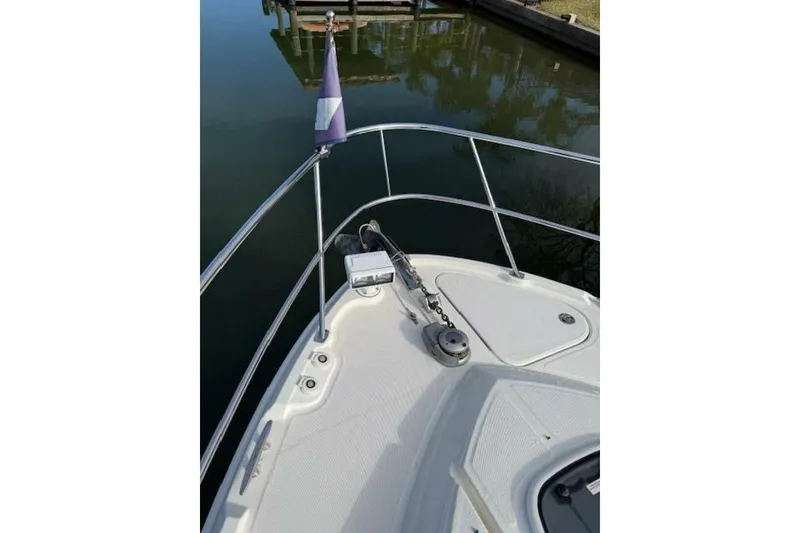 Slide: The Image of Bow view of 2016 Sea Ray Sundancer 400 yacht with anchor and flag. - 30