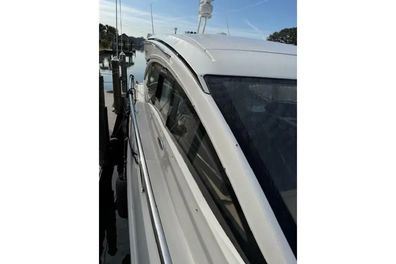 Slide: The Image of 2016 Sea Ray Sundancer 400 yacht docked, showcasing sleek design and modern features. - 32