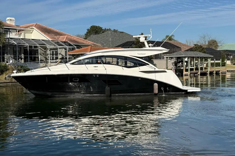 Slide: The Image of 2016 Sea Ray Sundancer 400 yacht docked near waterfront homes. - 39