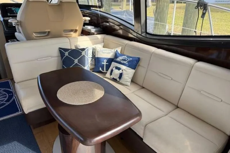 Slide: The Image of Luxurious interior of 2016 Sea Ray Sundancer 400 yacht with elegant seating and nautical-themed pillows. - 4